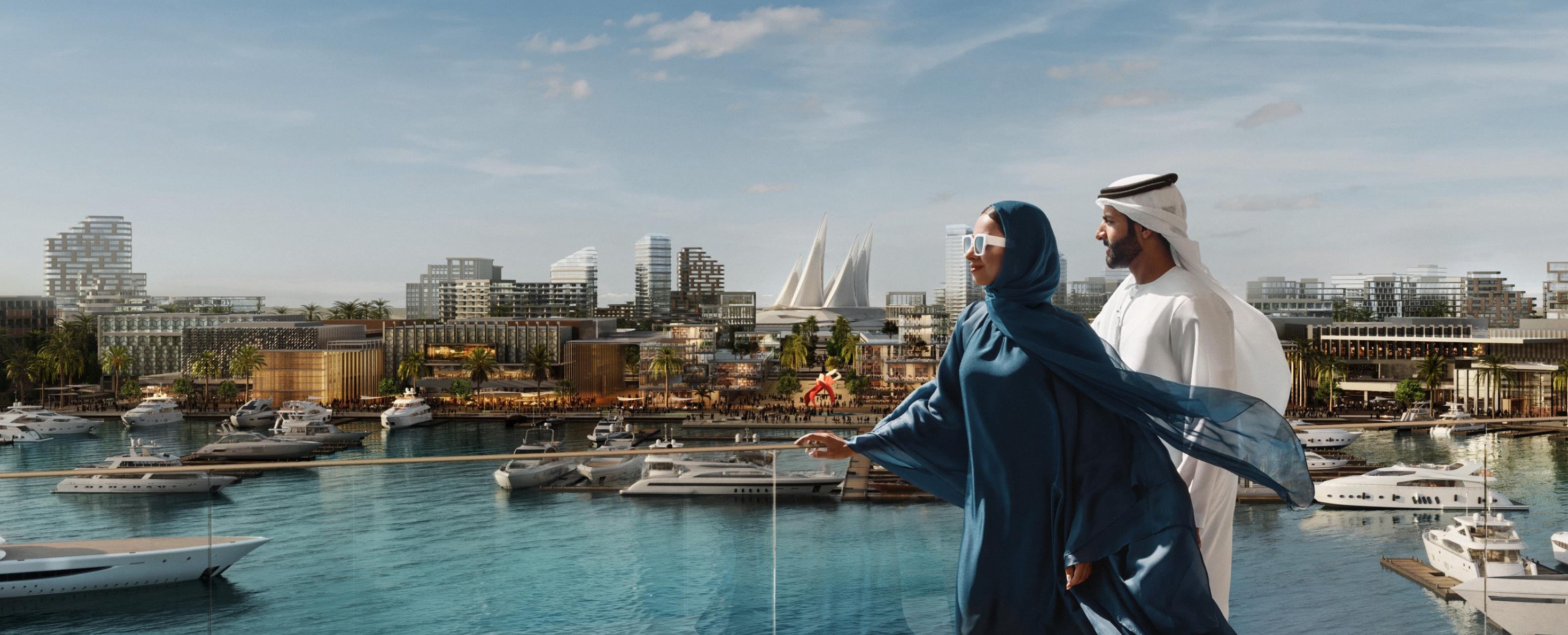 Couple overlooking the yacht marina at Marsa Al Saadiyat, Abu Dhabi skyline behind