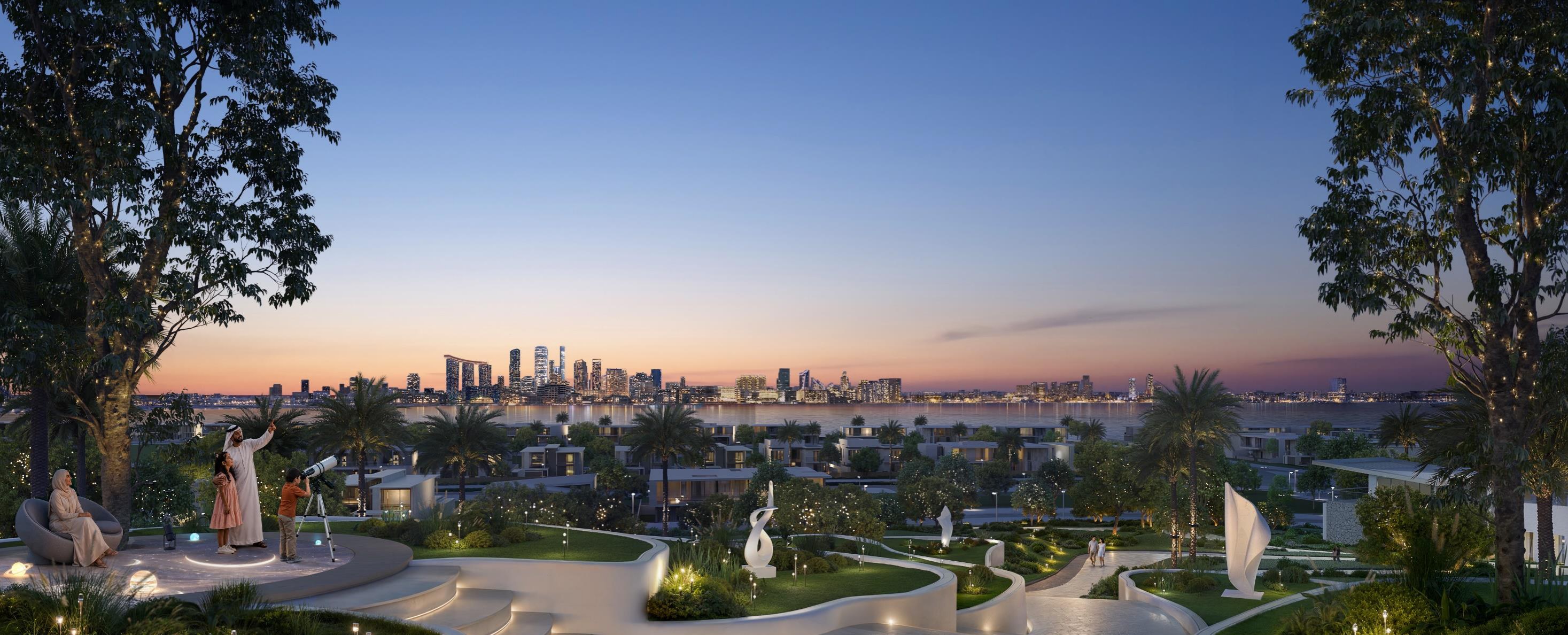 Marsa Al Saadiyat — dusk garden walkway with the Abu Dhabi skyline beyond