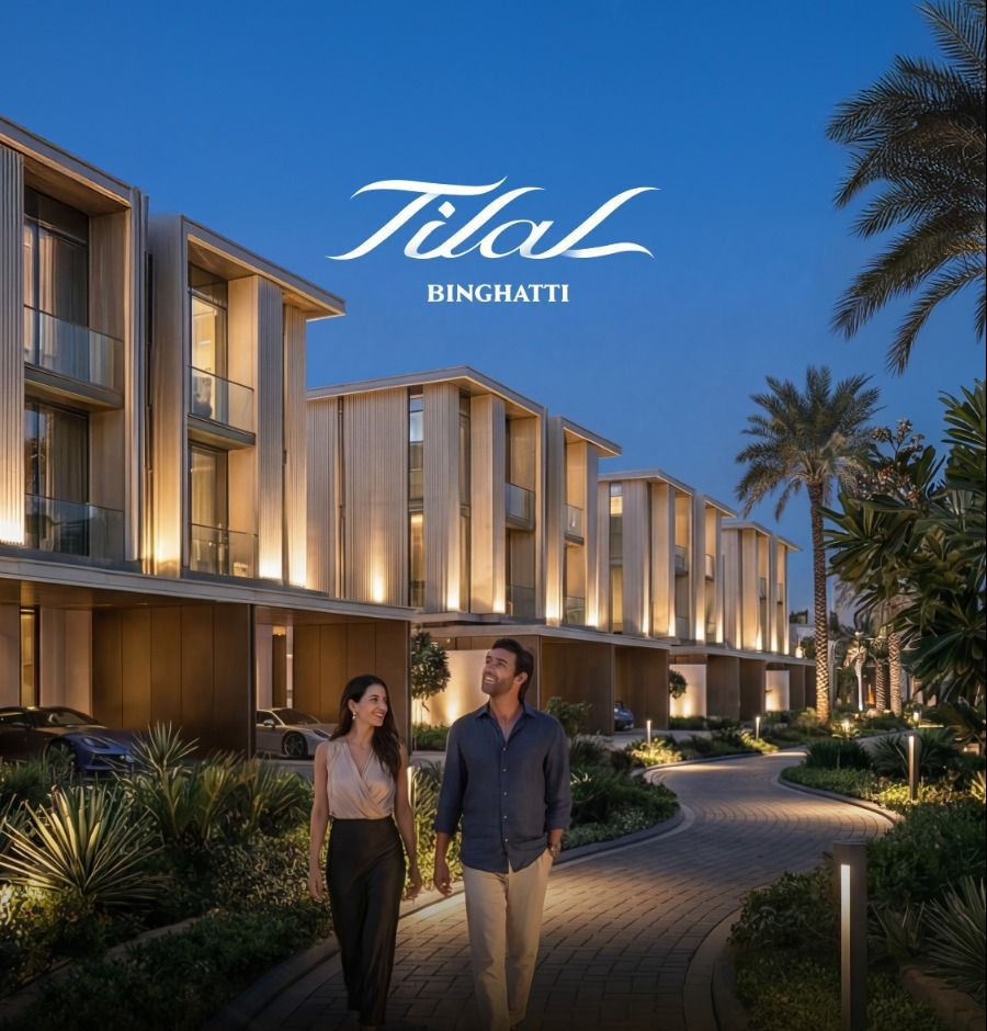 Tilal Binghatti at dusk — couple walking along a lit landscaped path between villas